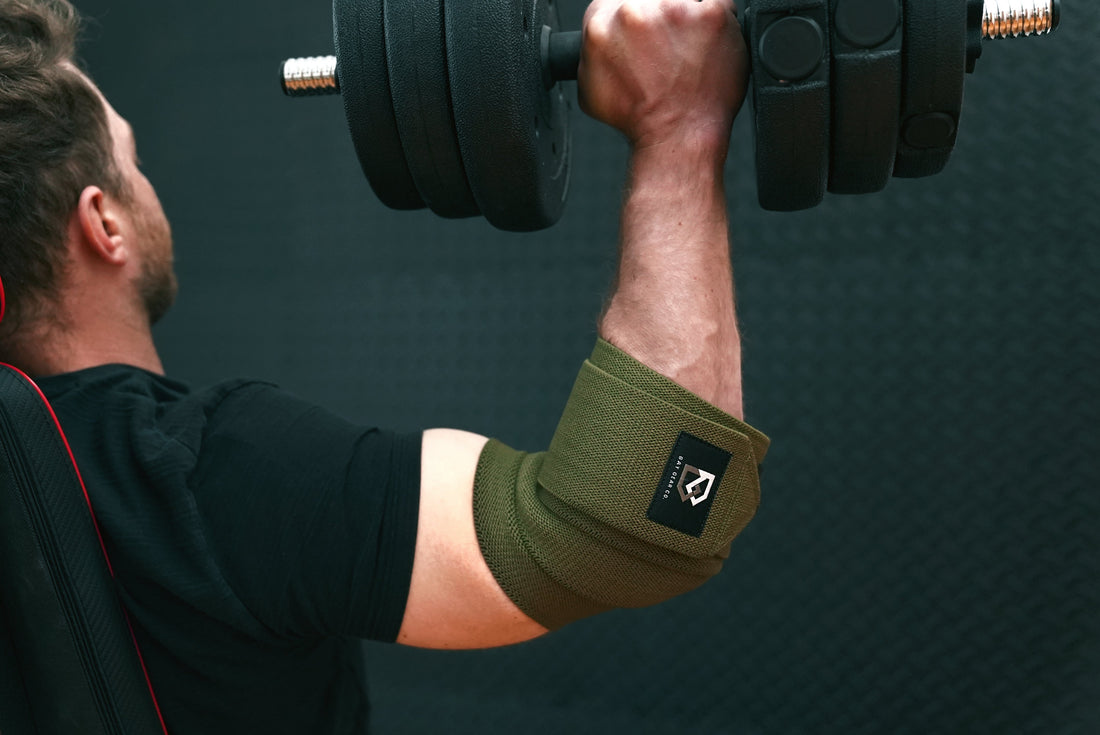 Will elbow wraps make you bench more? Lifter benching in Bay Gear Co. OD Green elbow wraps